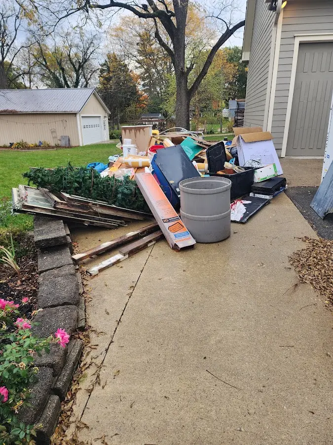 Dumpster being loaded with debris for Estate Cleanout Dumpster Rental in Phenix City